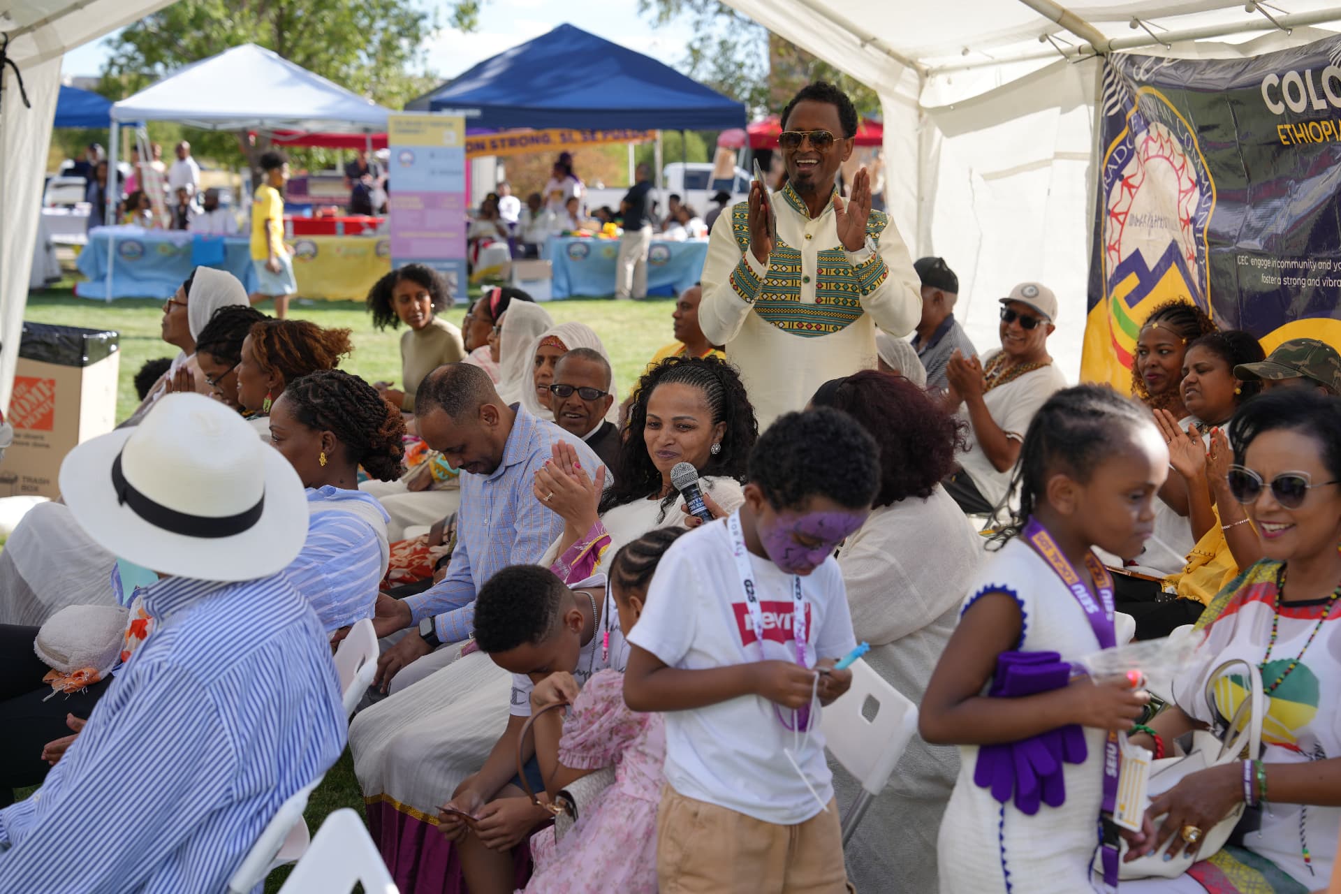 Community members gathered under tents at Ethiopian Day, celebrating together in Centennial Center Park